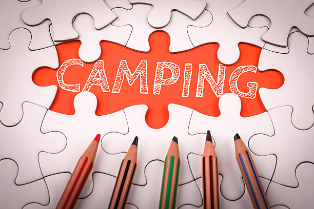 istock Camping. White puzzle pieces and colored pencils 2221041864