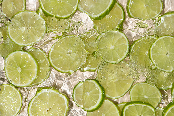 istock Fresh Limes In Motion. Splashing Water Top View 2221041995