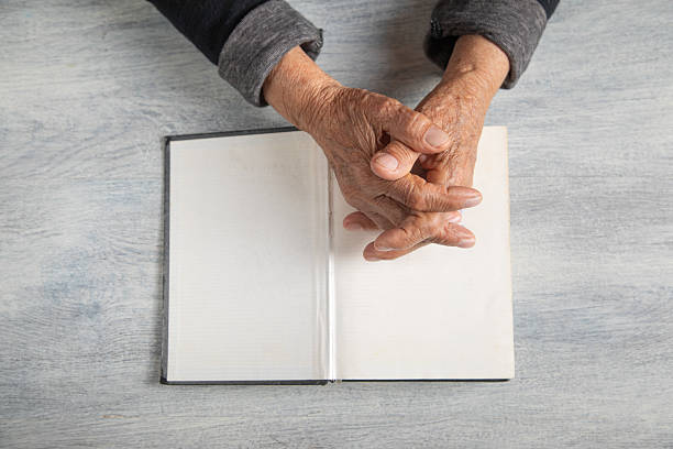 istock Caucasian elderly woman hand with bible. 2221042756