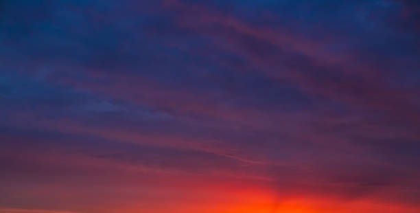 istock Evening sky with deep purple and orange hues against the setting sun 2221042899