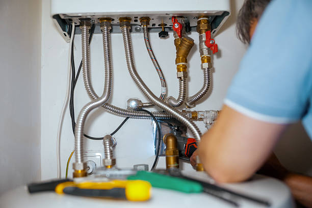 istock Plumber Actively Repairing a Water Heater 2221043815