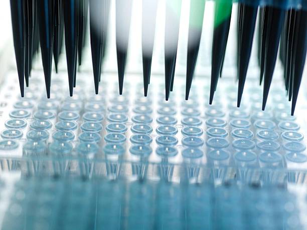 istock Automated Analysis, Samples being prepared in micro plates using automated pipettes in the lab 2221046737