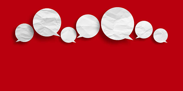 istock White speech bubble crumpled paper isolated on red background 2221048026