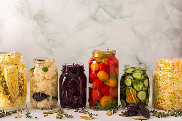 istock Fresh vegetables like cabbage, tomatoes, cucumbers, corn, peppers and cauliflower, fermenting naturally to boost health and preserve nutrients 2221048873