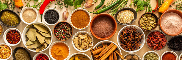 istock Collection of assorted spices and herbs spread on a beige background, blending exotic aromas and colors to inspire flavorful cooking, banner 2221048877