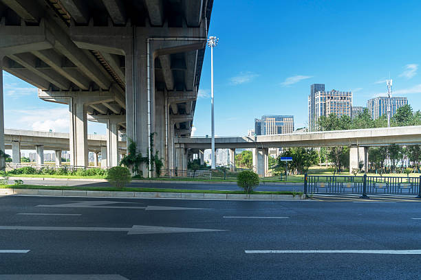 istock Concrete structure and asphalt road space under the overpass in the city 2221049100