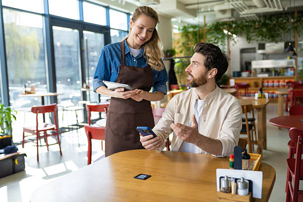 istock Pizzeria worker taking order from the client and looking friendly 2221050553