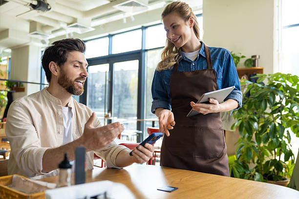 istock Pizzeria worker taking order from the client and looking friendly 2221050585