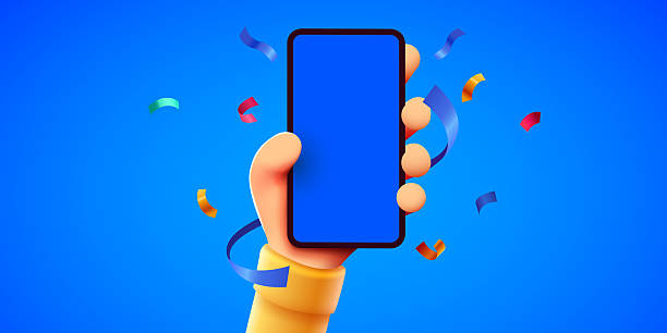 istock Cute 3D cartoon hand holding mobile smart phone with celebratory confetti flying around. Winner concept. Modern mockup. 2221050596