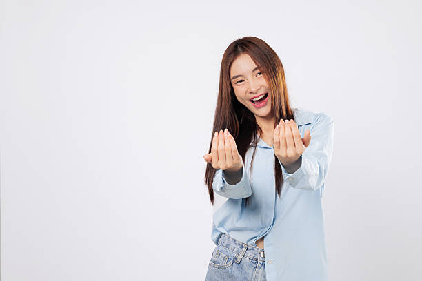 istock Woman gestures come here with open palm, second woman inviting with cheerful face 2221050784