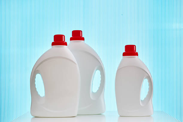 Three bottles of laundry gel on a blue background. High quality photo.