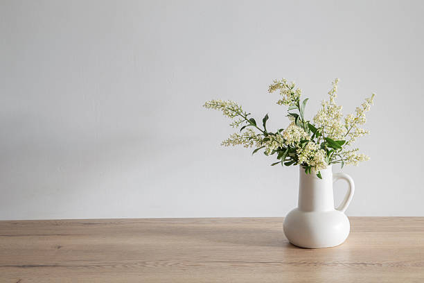istock white lilac flowers in vase on wooden table 2221052618