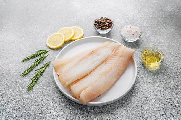 istock Raw pollock fillet with seasoning ingredients on gray background 2221054881
