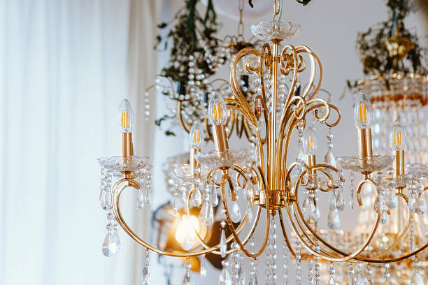 istock Elegant chandelier with crystals illuminated in a bright indoor space 2221055098
