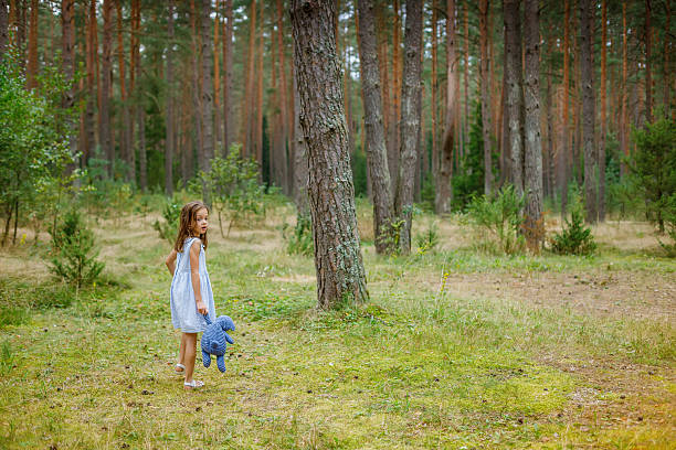 A small child clutching a teddy bear while entering a dense forest. The scene represents wonder, escapism, and the comfort of childhood memories, blending innocence with a touch of mystery