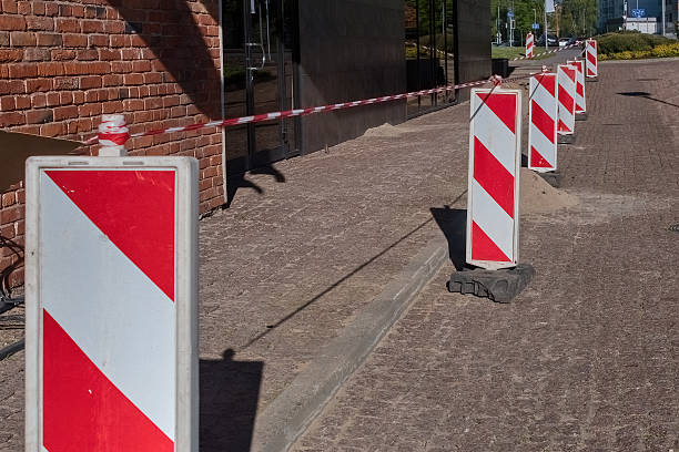 istock Sidewalk Restoration with Stone Pavement. Construction Work Next to Brick Wall. 2221056345
