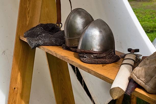 istock Medieval Armor and Weapons Display Outdoors. Reenactment Gear with Axe and Helmets. Viking Style Equipment at Medieval Fair. 2221056516