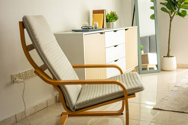 Luxury studio apartment, view from living room to white large kitchen and round dining table