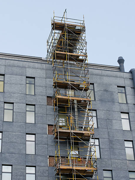 istock External lift hoist at modern high rise flats being constructed 2221061057
