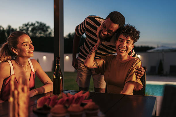 istock Friends laughing and having fun during a summer evening dinner party 2221061814