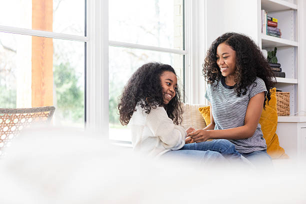 istock Happy Sisters Bonding by Window, Casual Attire 2221063185