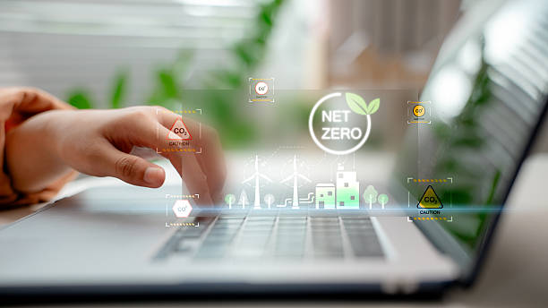 istock Person working on laptop with virtual Net Zero and CO2 emission icons, representing ESG strategy, carbon footprint analysis, and environmental sustainability in modern business. 2221063582