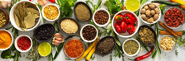 istock Assorted cooking spices and herbs arranged on a gray surface, featuring natural tones that add depth and aroma to any meal, banner 2221064193