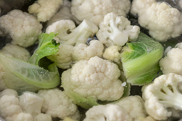 istock Fresh cauliflower is boiled in a water. The vegetable is divided into florets and boiled 2221064661