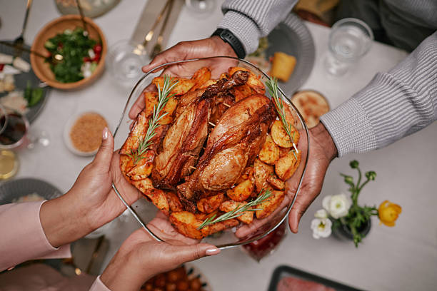 istock Sharing Dish of Roasted Chicken and Vegetables during Festive Dinner 2221065513