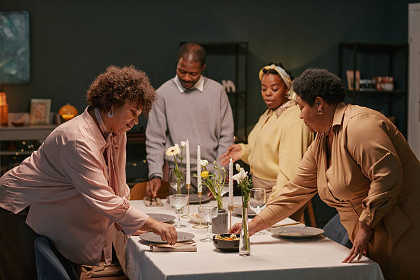 istock Black Family Serving Table for Thanksgiving Celebration at Home 2221065515