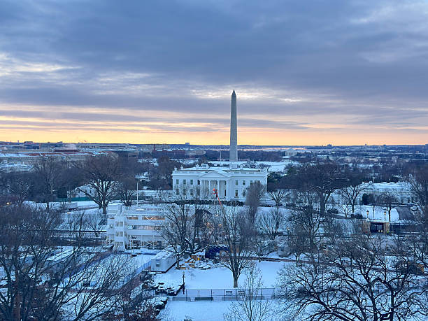 istock High Angle view of the White House before dawn, covered in snow. 2221066003