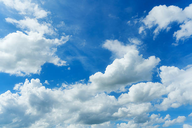 istock White fluffy clouds in blue sky on sunny day 2221066113