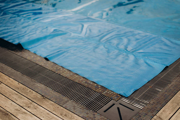 istock Blue pool cover protecting water in swimming pool 2221066401