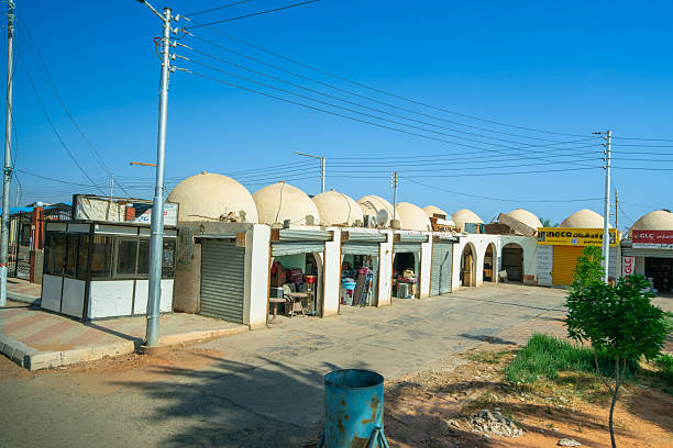 Abu Simbel Temples, Egypt - January 16, 2025: Street shops with dome roofs line the roadside under a clear sky. Local wares and traditional charm enrich the temple surroundings.