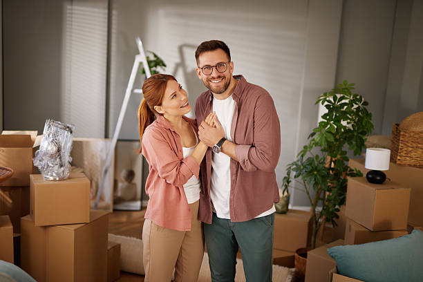 istock Happy couple holding hands while moving into new home 2221069138