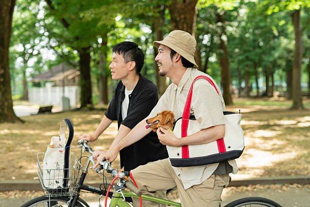 Two men came to the park on bicycles with their dogs