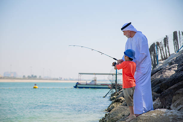 istock Two generations fishing together 2221073423