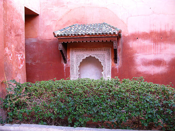 Antique ornate window in the medina of Marrakech, Morocco. Window of a mosque.