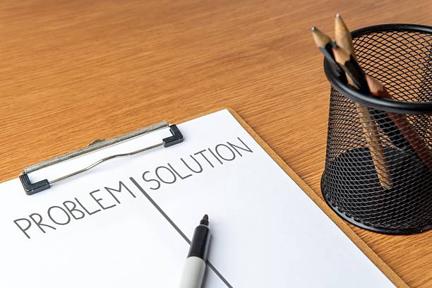 istock Closeup image of paper clipboard with PROBLEM and SOLUTION written on its pages. 2221079262