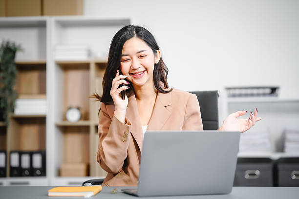 istock An Asian businesswoman works at her desk office, smiling while analyzing financial data planning business strategies on her laptop to enhance profitability,optimize resources,ensure financial growth 2221083310