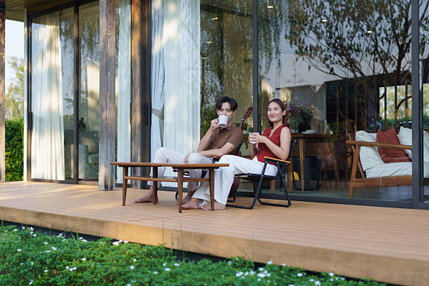 istock A young man covers his girlfriend with a blanket and drinks coffee on their front porch on a winter weekend. 2221083956
