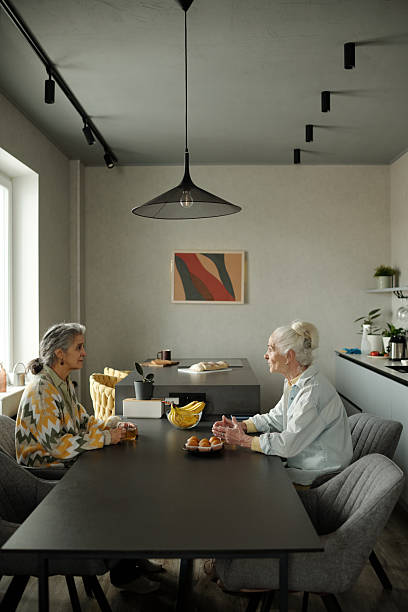 istock Senior Women Engaging in Conversation at Dining Table 2221084071
