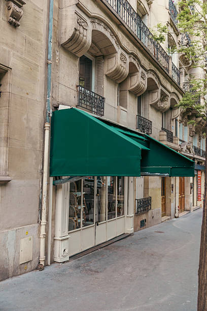 Classic Parisian Cafe Facade with Green Awnings and Windows