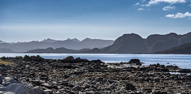 istock Scenic Coastal View with Mountains and Rocks Under Dramatic Cloudy Sky, Runde, Norway 2221087395