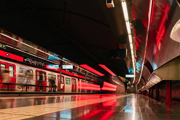 Blurred red train rushing into a subway station, with passengers waiting on the platform, creating a dynamic urban commuting scene