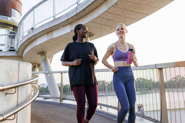 istock Two women jogging on a bridge during a scenic outdoor morning routine 2221093545