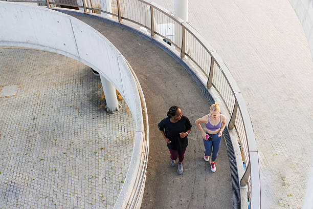 istock Two women jogging on a pathway outdoors, captured from an aerial perspective 2221093700