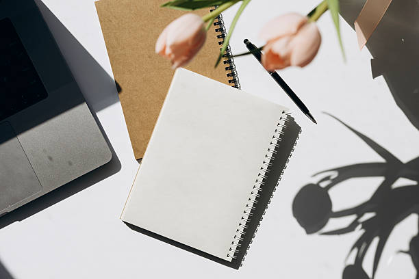 istock Flat lay with flowers and paper note with space for text. Woman workspace. 2221096503