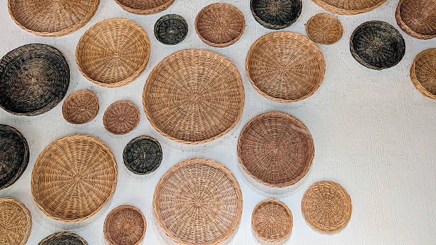 istock Woven wicker baskets in neutral tones clustered against pristine white wall, creating textural display with minimalist design and generous negative space for graphic applications 2221097491
