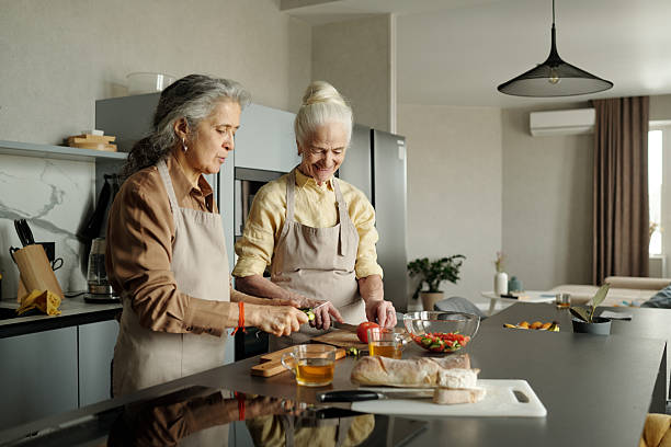 istock Elderly Women Preparing Meal in Modern Kitchen 2221099821